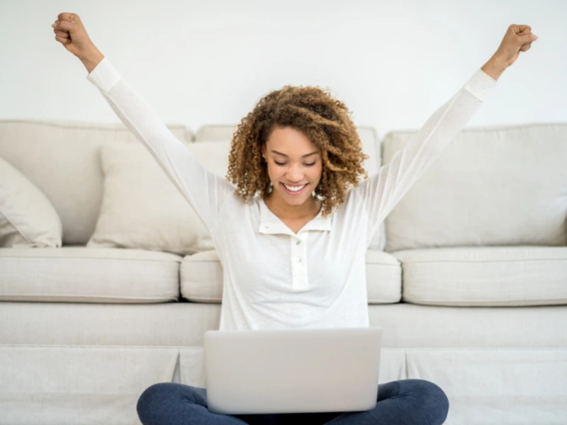 woman celebrating her new website on laptop